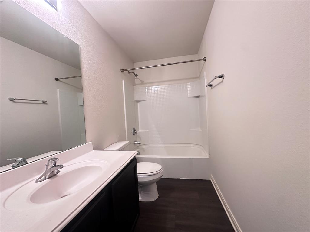 14310 Wrangler Way Dallas, TX 75253 - Photo 18 of 29 a bathroom with a sink a toilet a shower and a mirror