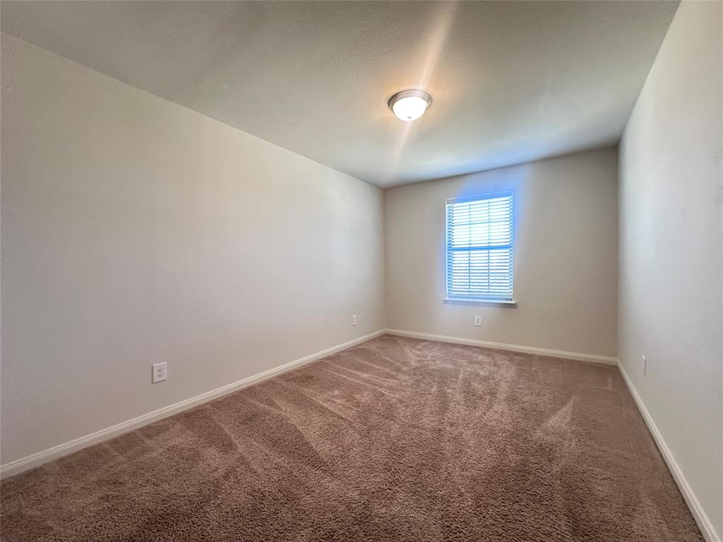 14310 Wrangler Way Dallas, TX 75253 - Photo 19 of 29 an empty room with windows
