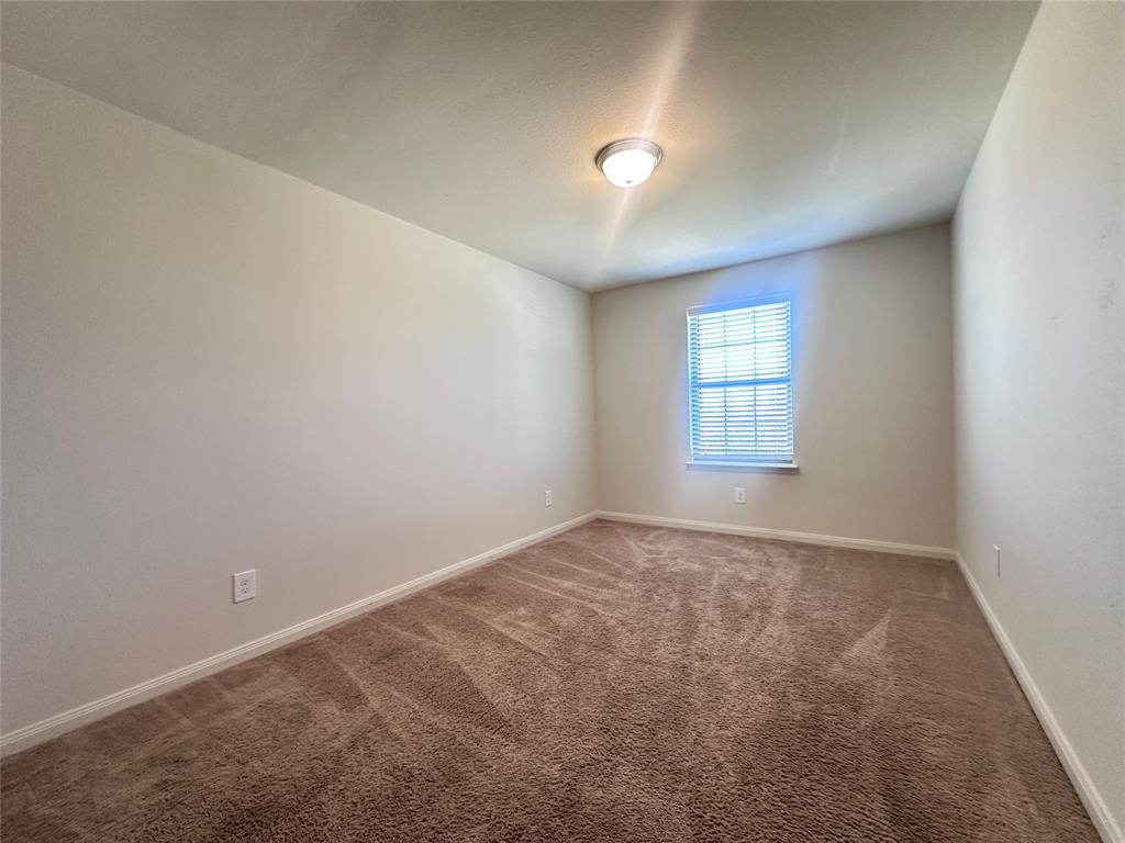 14310 Wrangler Way Dallas, TX 75253 - Photo 20 of 29 an empty room with windows