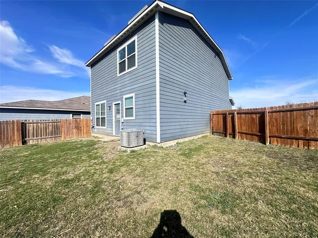 a view of backyard of house and deck