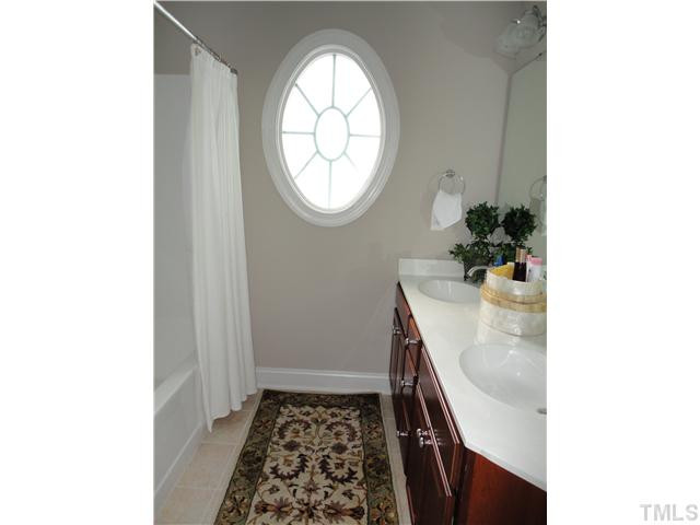 2 Rosemeade Place Durham, NC 27712 - Photo 18 of 20 a room with a sink and a mirror