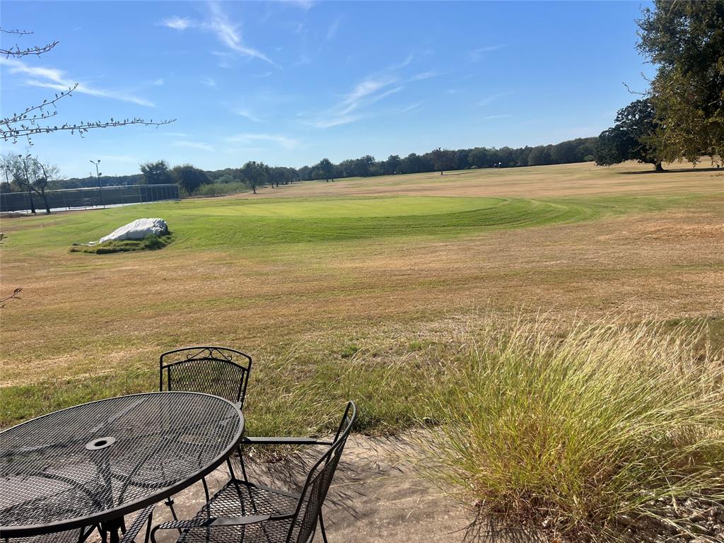 13104 Range Court Whitney, TX 76692 - Photo 6 of 6 View of grassy yard with golf course view and outdoor dining space