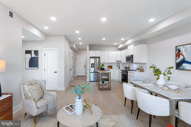 a living room with furniture kitchen and a kitchen view