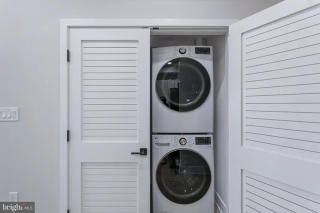 a view of a hallway with livingroom and furniture