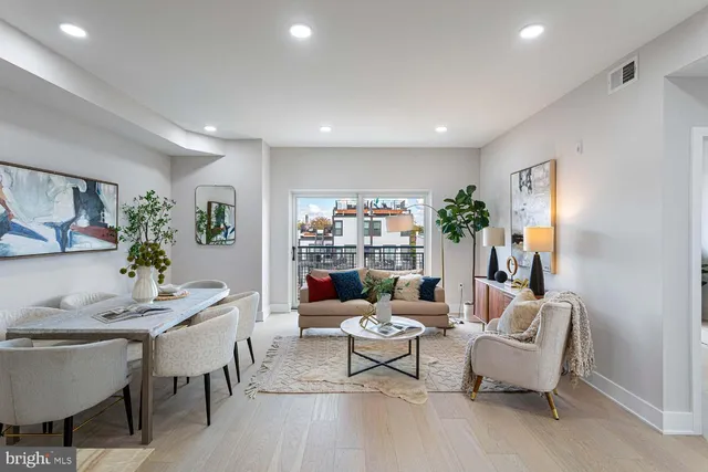 a living room with furniture a dining table and kitchen view