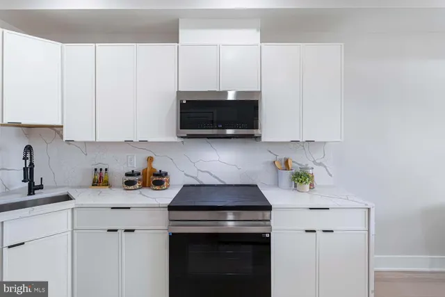 a bathroom with a sink mirror vanity and toilet