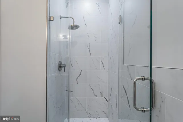 a bedroom with a bed and painting on the wall