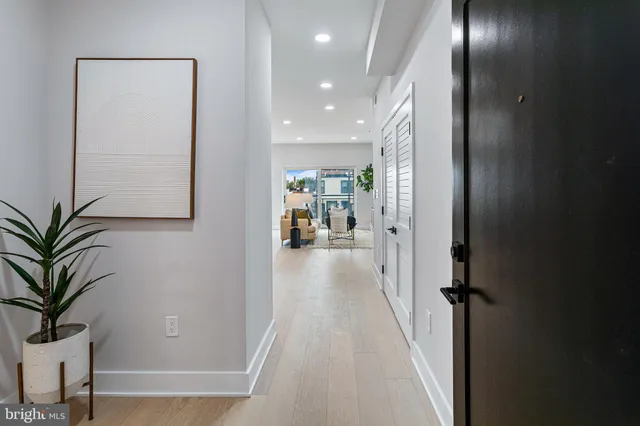 a bedroom with a bed and a potted plant