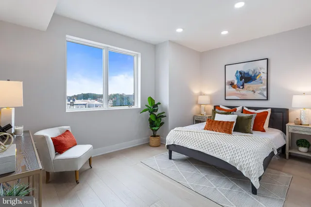 a bedroom with a bed potted plant and a window