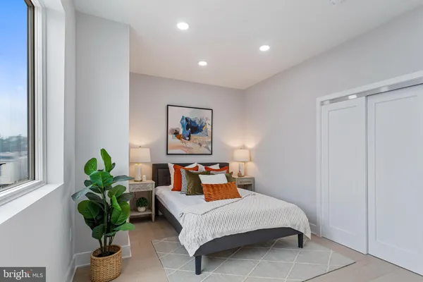 a bedroom with bed and a window