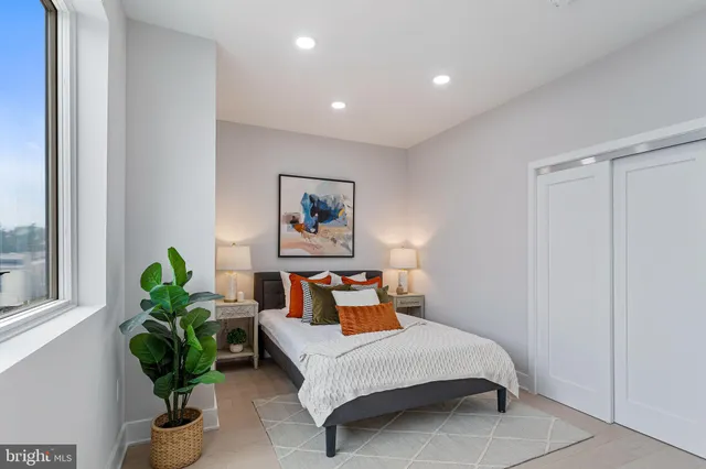 a bedroom with bed and a window