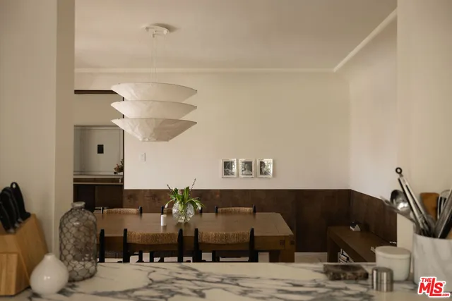 a view of a dining room with furniture and chandelier