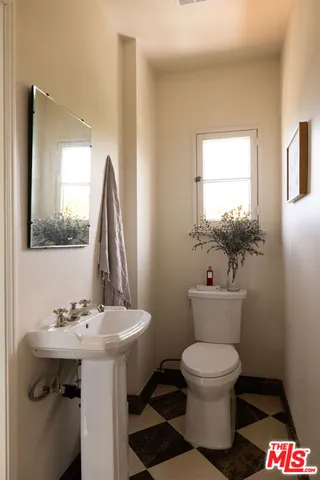 a view of a workspace with furniture and a potted plant