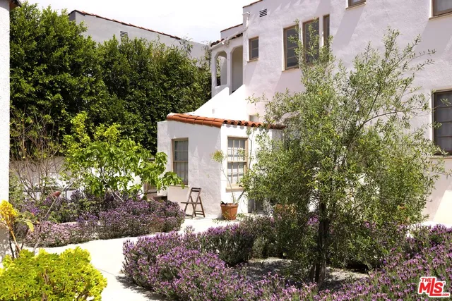 a bedroom with furniture and a flat screen tv