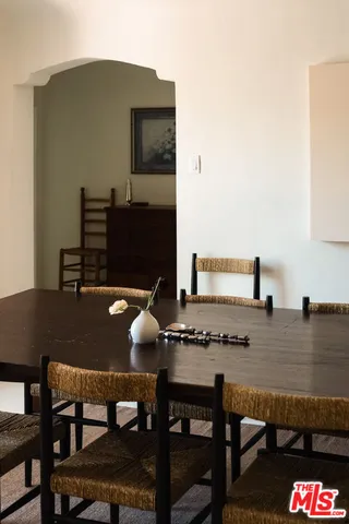 a view of a dining room with furniture and a window