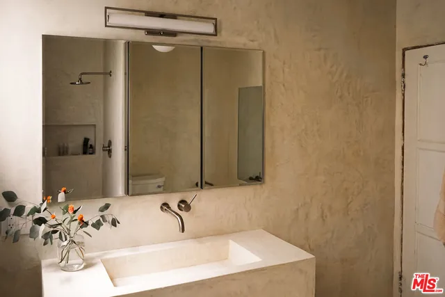 a bathroom with a granite countertop toilet and a shower