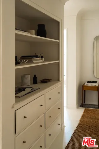 a view of a workspace with furniture and a window