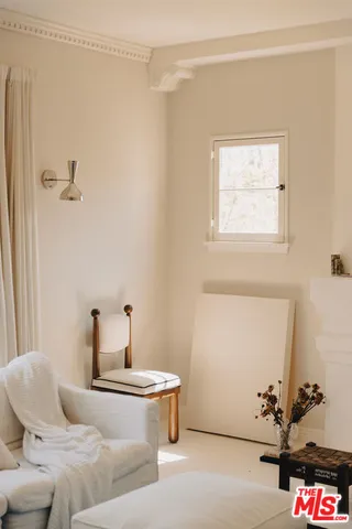 a bedroom with a bed and a table with mirror