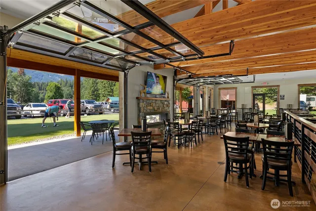 a view of a dining room with furniture and a floor to ceiling window