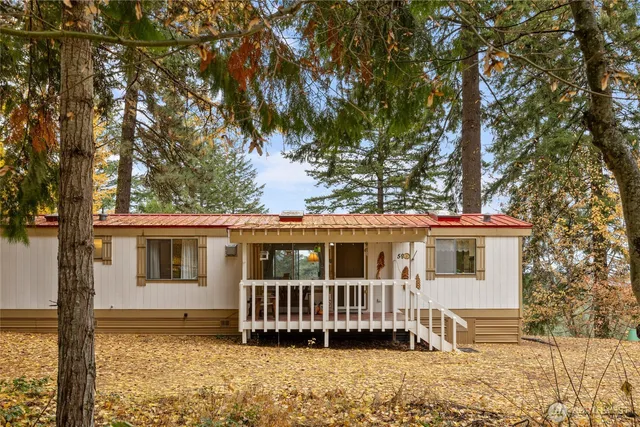 a view of a house with a yard and wooden fence