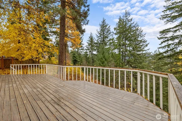 a balcony with wooden floor and fence