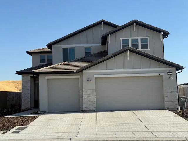 a front view of a house with garage
