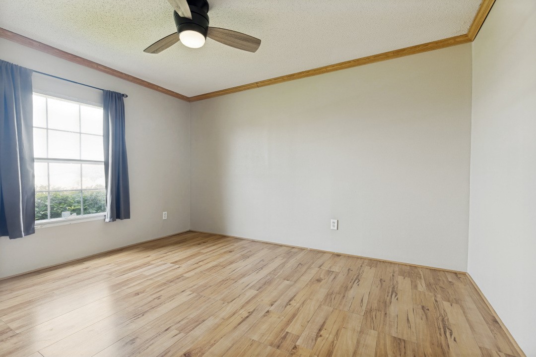 207 Vivian Road Onalaska, TX 77360 - Photo 25 of 34 wooden floor in an empty room with a window