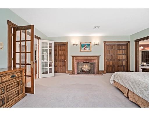 3 Virginia Place Wenham, MA 01984 - Photo 20 of 30 a spacious bedroom with a bed and a fireplace