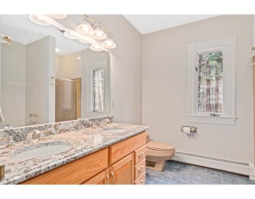 3 Virginia Place Wenham, MA 01984 - Photo 24 of 30 a bathroom with a granite countertop sink a toilet a mirror and shower