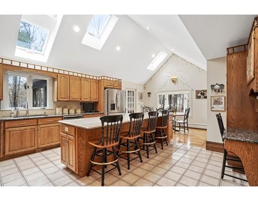 3 Virginia Place Wenham, MA 01984 - Photo 7 of 30 a open dining room with stainless steel appliances kitchen island granite countertop a table chairs and a refrigerator