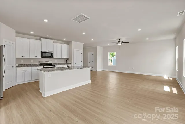 a view of kitchen with cabinets and wooden floor
