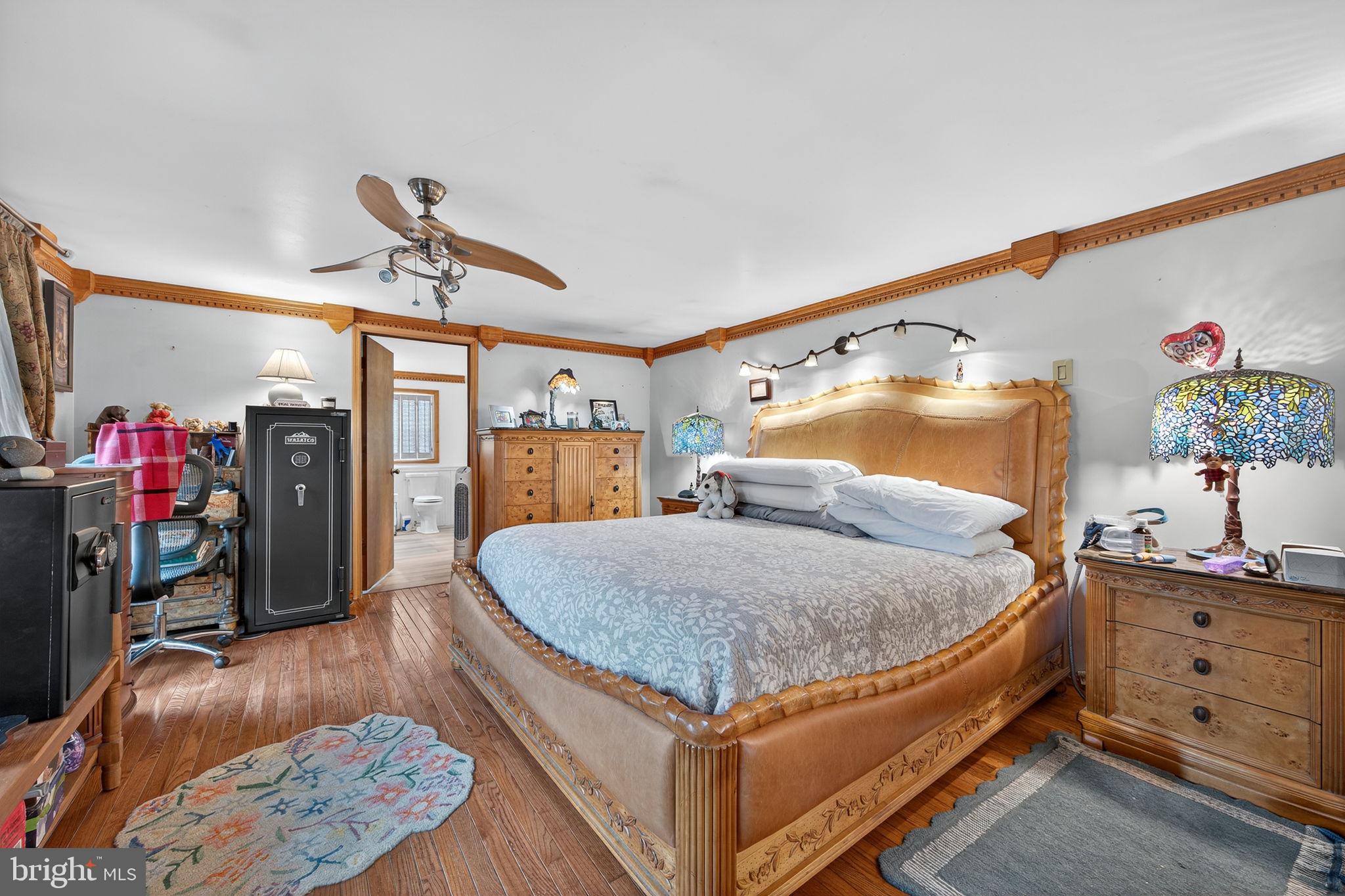 3337 Downs Chapel Road Clayton, DE 19938 - Photo 13 of 54 a bed room with a bed and a chandelier