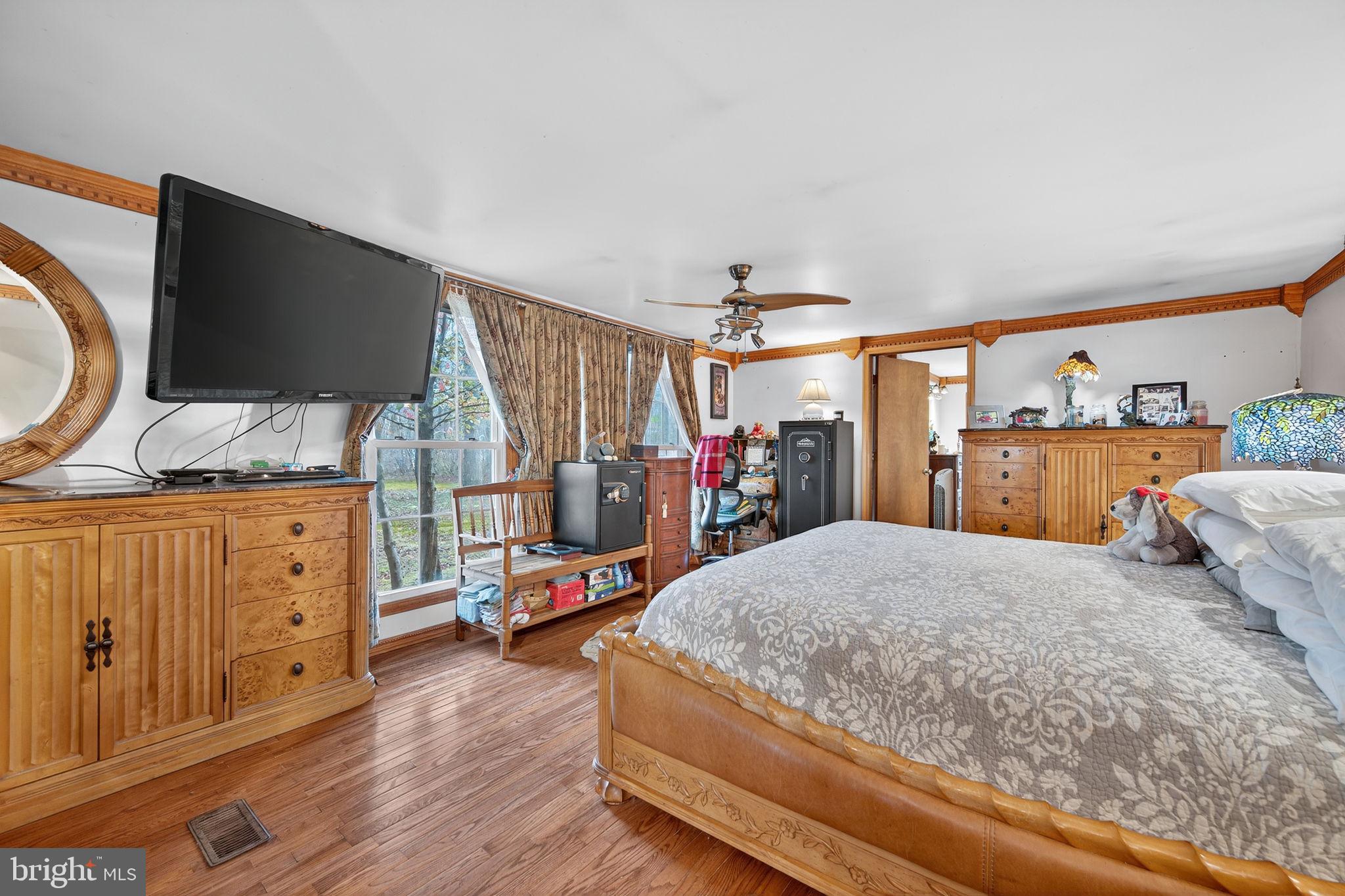 3337 Downs Chapel Road Clayton, DE 19938 - Photo 14 of 54 a bedroom with a bed and a flat tv screen on dresser
