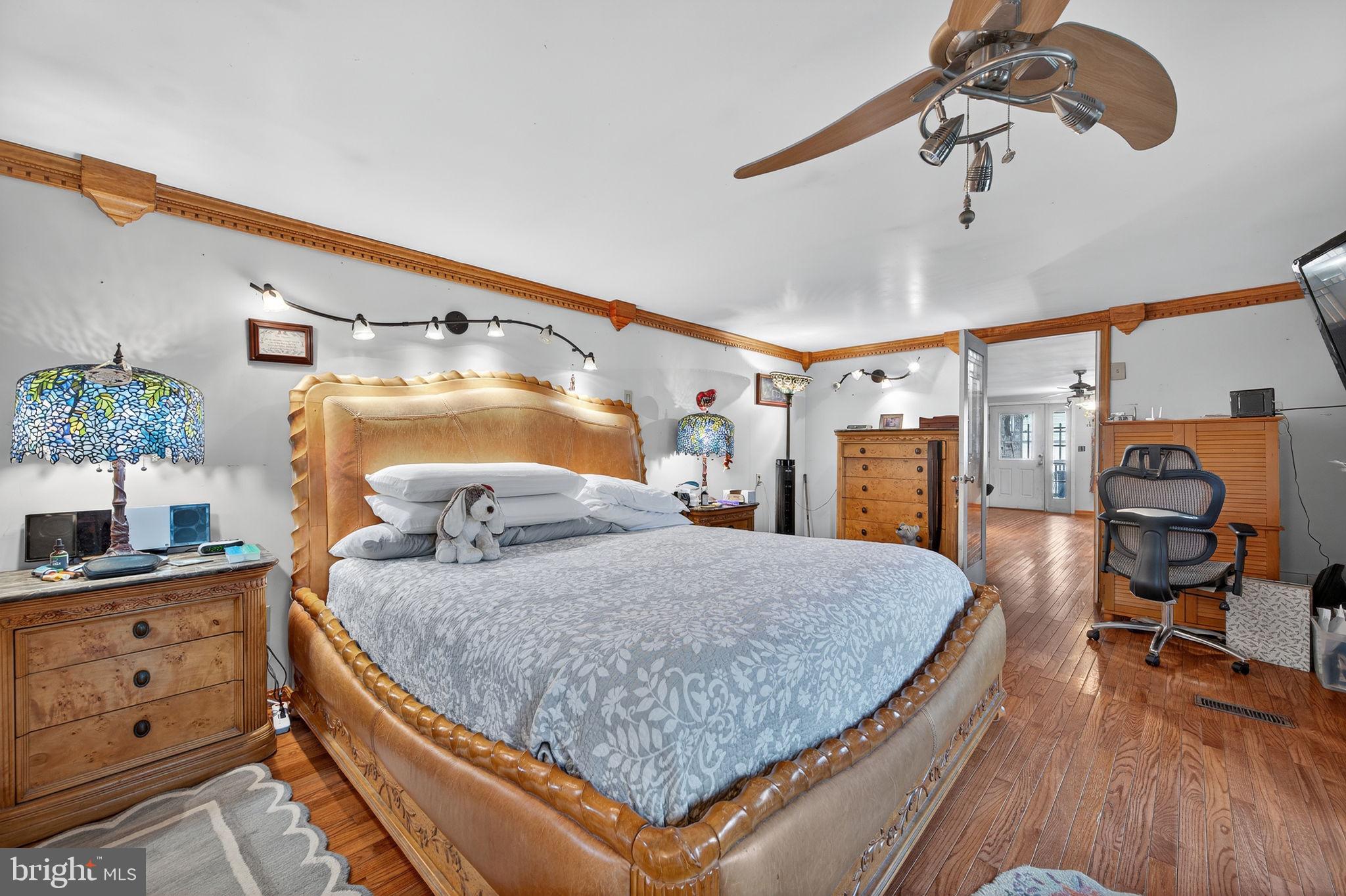 3337 Downs Chapel Road Clayton, DE 19938 - Photo 15 of 54 a bedroom with a bed and wooden floor