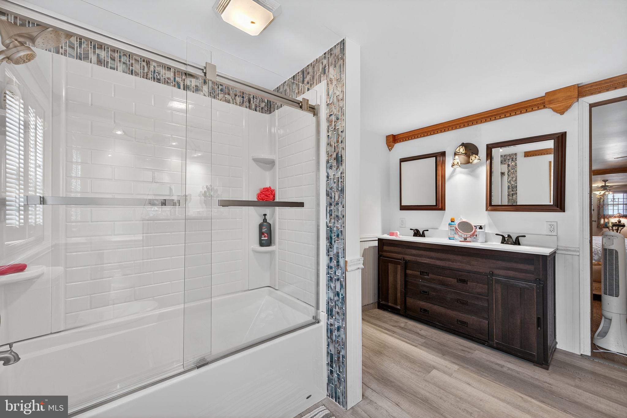 3337 Downs Chapel Road Clayton, DE 19938 - Photo 18 of 54 a bathroom with a bathtub shower sink vanity and mirror