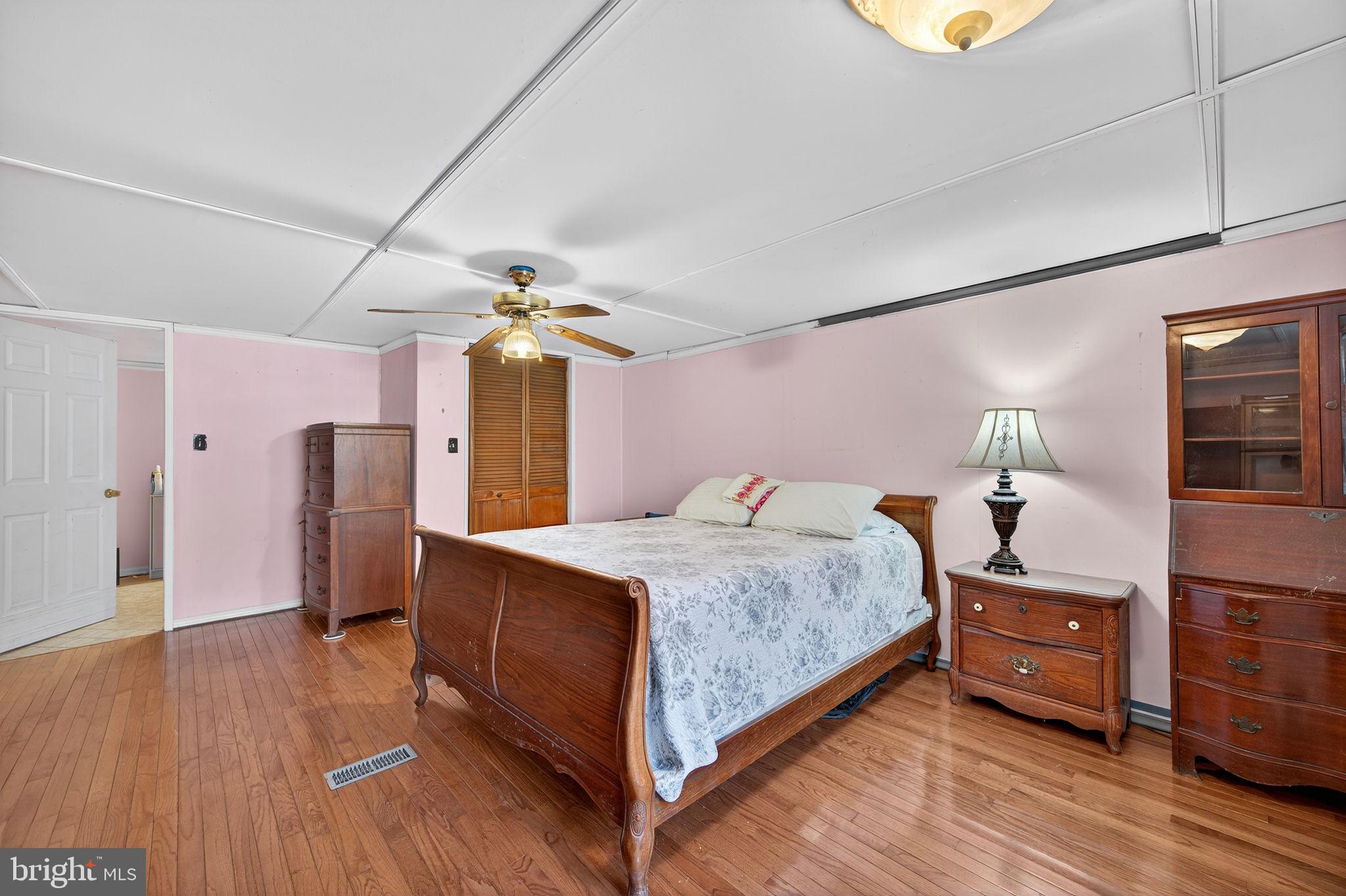 3337 Downs Chapel Road Clayton, DE 19938 - Photo 21 of 54 a bedroom with a bed and wooden floor