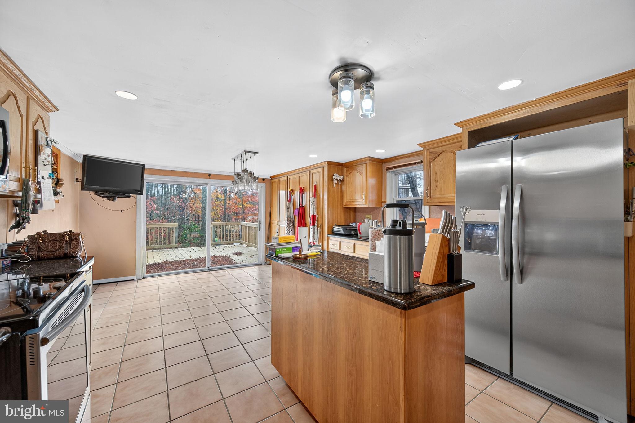 3337 Downs Chapel Road Clayton, DE 19938 - Photo 30 of 54 a kitchen with stainless steel appliances granite countertop a refrigerator and a sink
