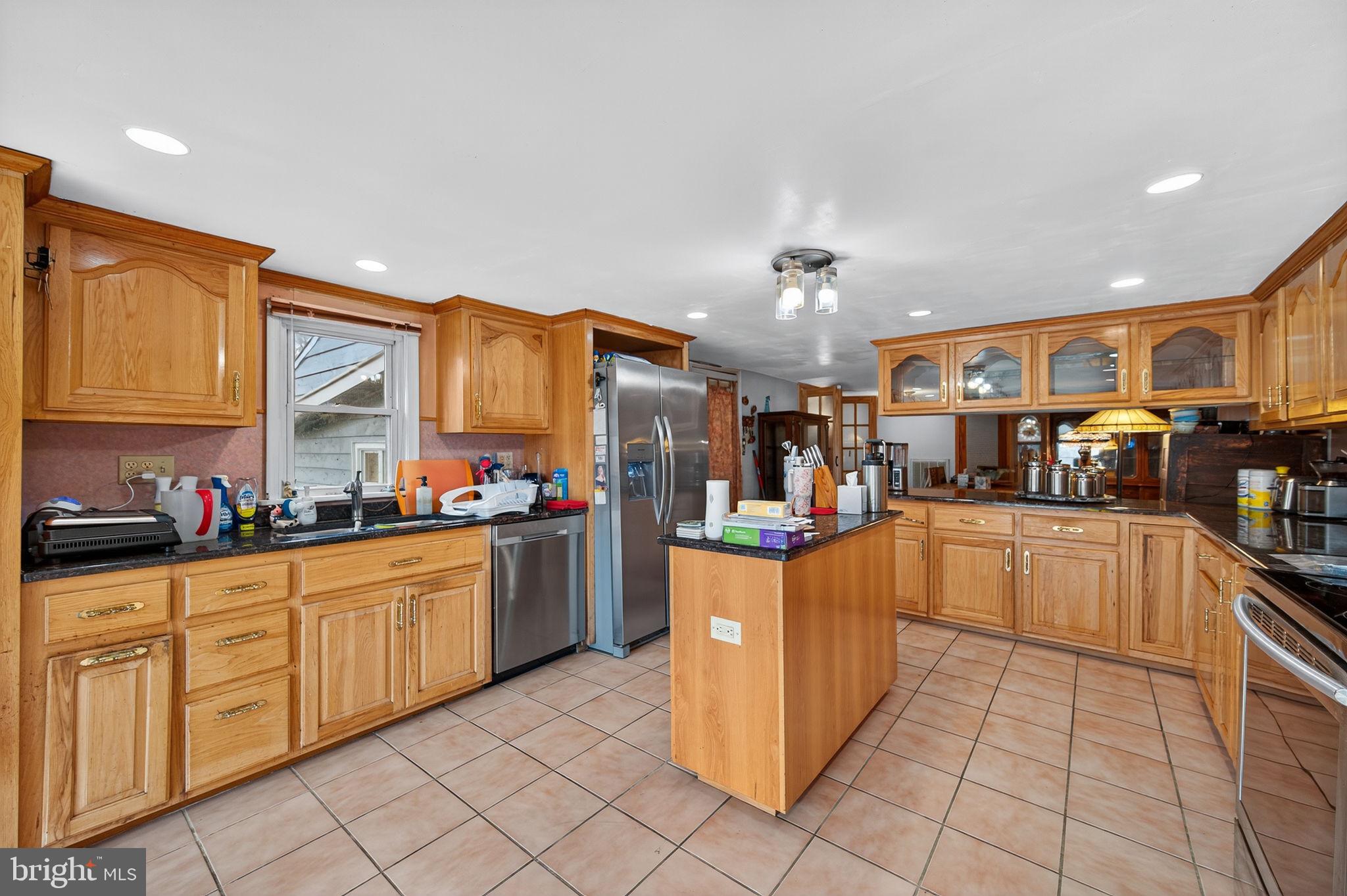 3337 Downs Chapel Road Clayton, DE 19938 - Photo 31 of 54 a kitchen with stainless steel appliances granite countertop a stove top oven a sink dishwasher and cabinets with wooden floor