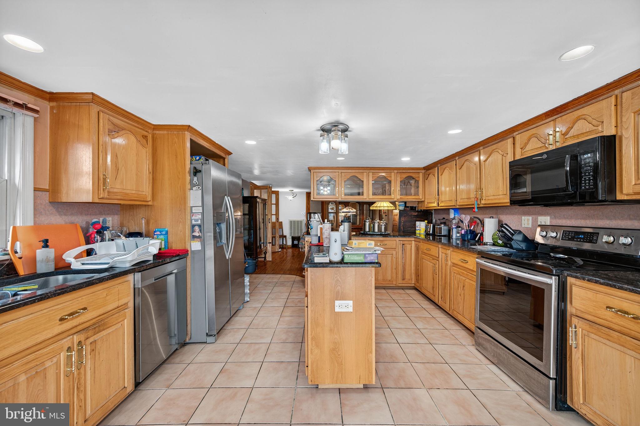 3337 Downs Chapel Road Clayton, DE 19938 - Photo 32 of 54 a kitchen with stainless steel appliances granite countertop a refrigerator and a stove top oven