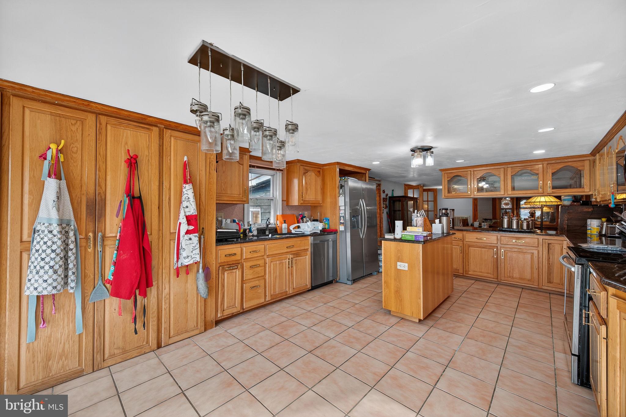 3337 Downs Chapel Road Clayton, DE 19938 - Photo 34 of 54 a kitchen with stainless steel appliances granite countertop a refrigerator and a stove top oven
