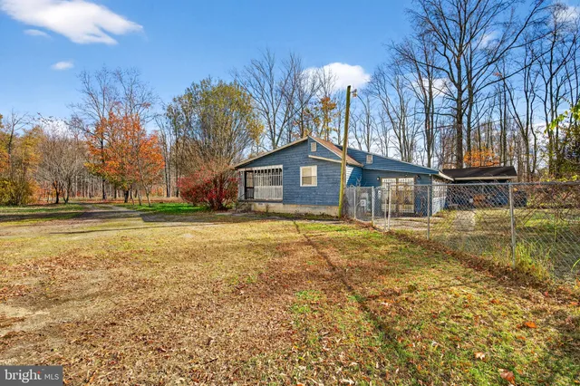 a house view with swimming pool in front of it