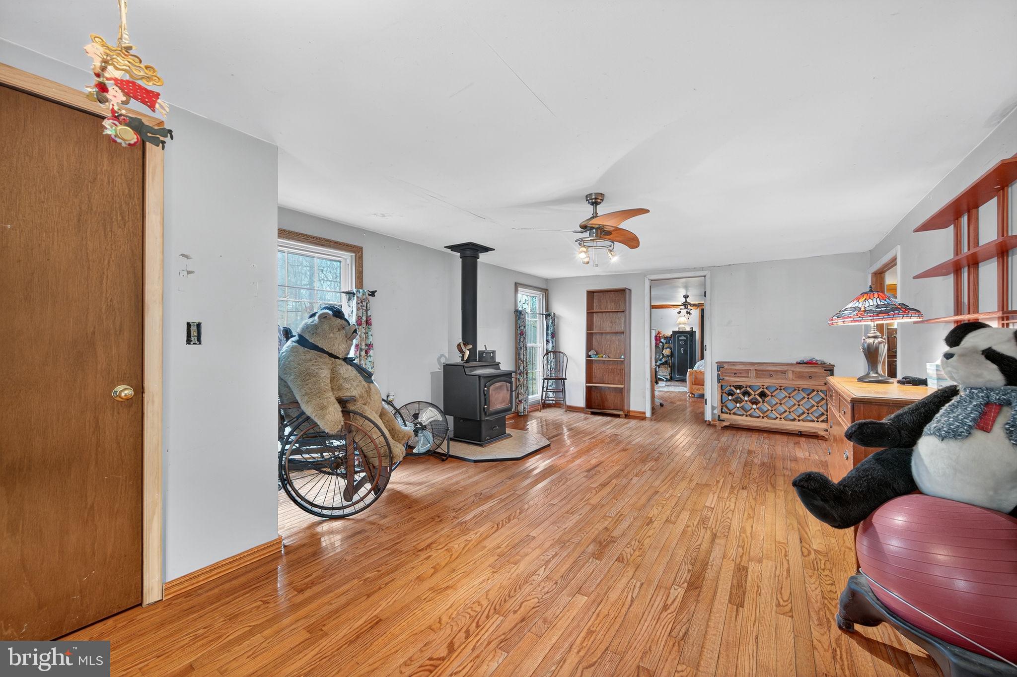 3337 Downs Chapel Road Clayton, DE 19938 - Photo 10 of 54 a living room with furniture a dining table and chairs with wooden floor