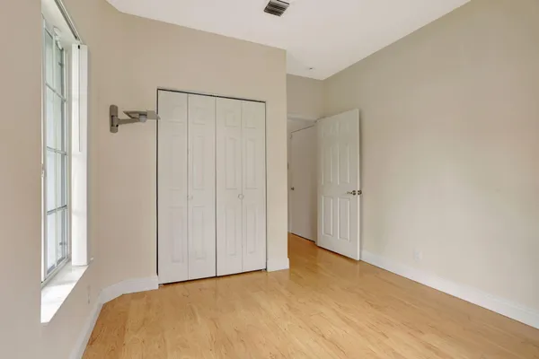 a view of a room with a wooden floor and cabinet