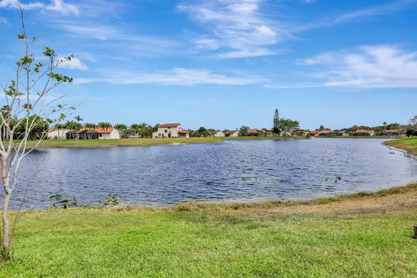 a view of a lake with houses in the back