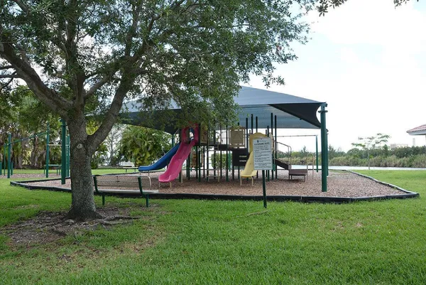 a view of playground with a slide and swing