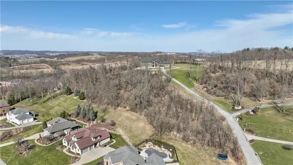 an aerial view of a house with a lake view