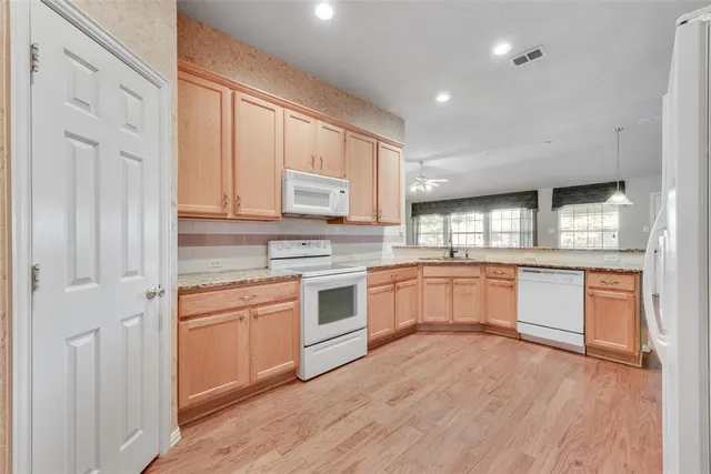 a kitchen with a white cabinets and white appliances