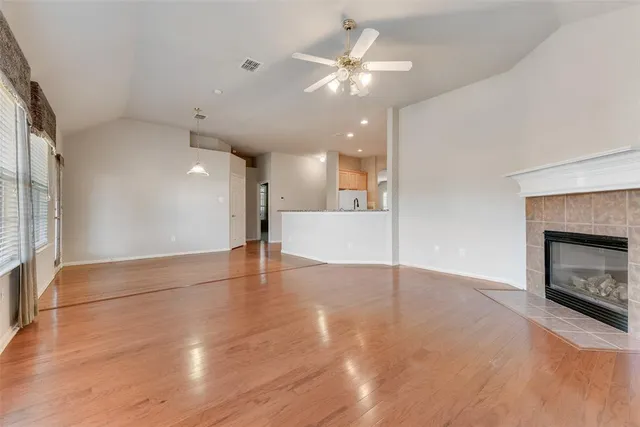 wooden floor in an empty room with a fireplace