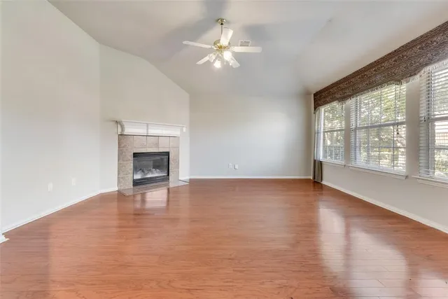 a view of an empty room with glass door and a window
