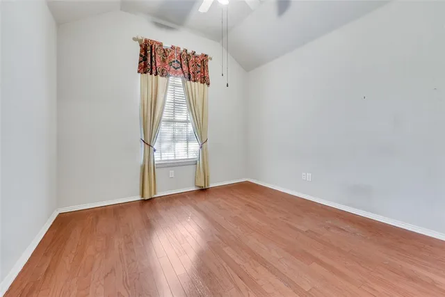 a view of a room with wooden floor and window